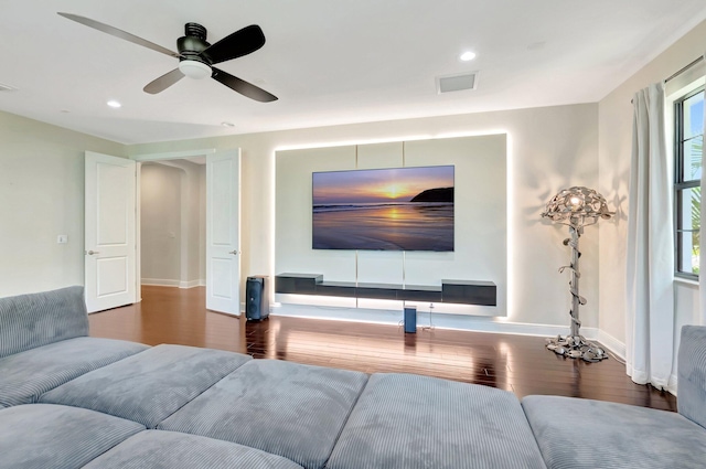 living area with wood finished floors, recessed lighting, visible vents, and baseboards
