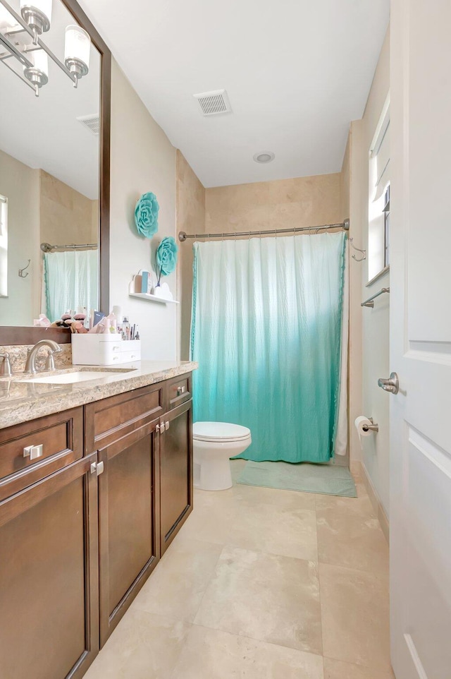 bathroom with visible vents, a shower with shower curtain, toilet, and vanity