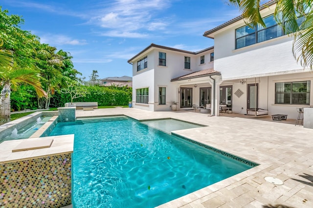 view of swimming pool with a jacuzzi, a fenced in pool, and a patio area