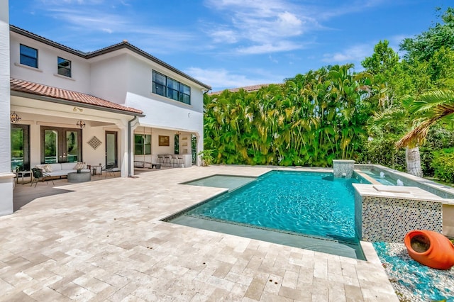 outdoor pool featuring an outdoor living space, a hot tub, and a patio area