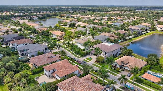 birds eye view of property with a water view and a residential view