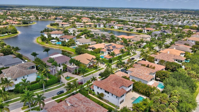 birds eye view of property with a water view and a residential view