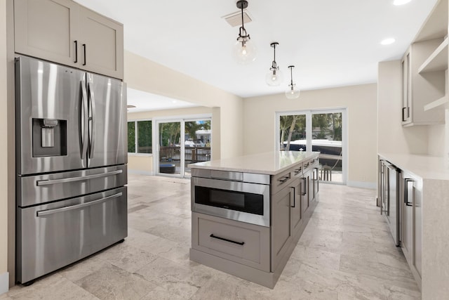 kitchen with stainless steel fridge, open shelves, a healthy amount of sunlight, and visible vents