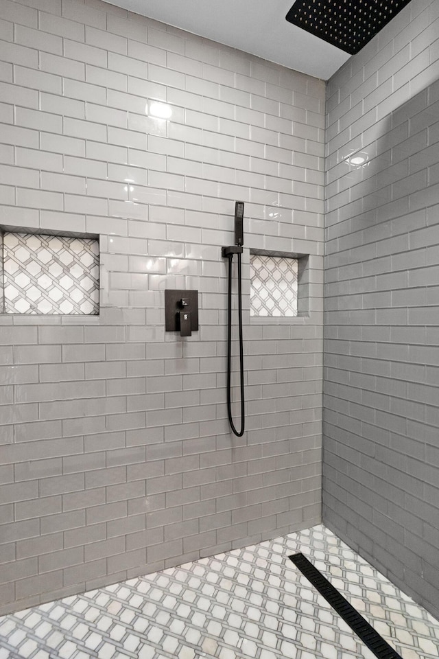 bathroom with a tile shower