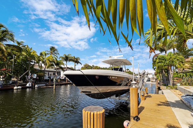 view of dock featuring boat lift and a water view