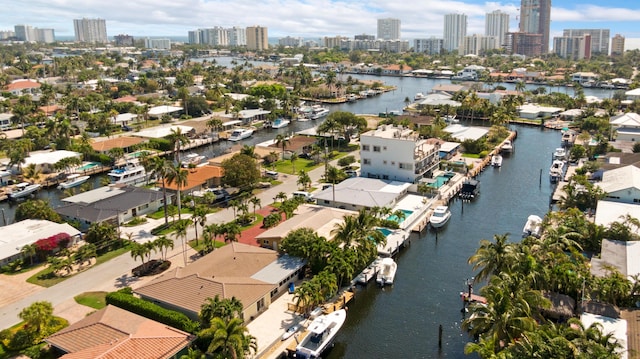 birds eye view of property with a water view, a city view, and a residential view