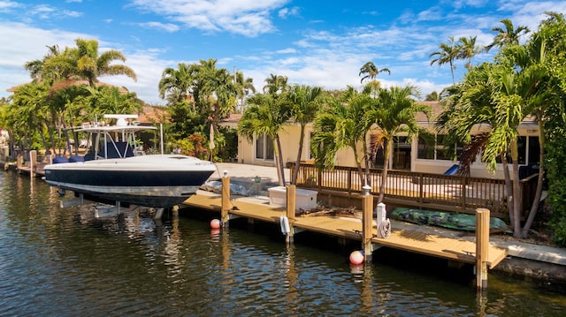 view of dock with boat lift and a water view
