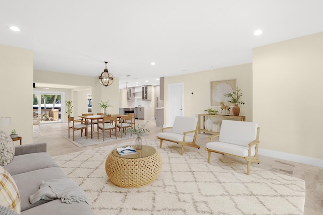 living area with recessed lighting, baseboards, and an inviting chandelier