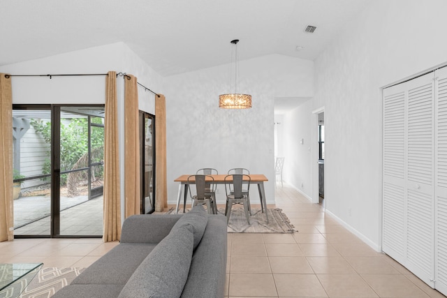 dining space featuring a notable chandelier, visible vents, baseboards, light tile patterned flooring, and high vaulted ceiling
