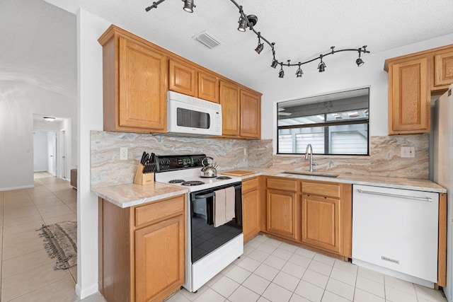 kitchen featuring a sink, light countertops, dishwashing machine, range with electric stovetop, and white microwave
