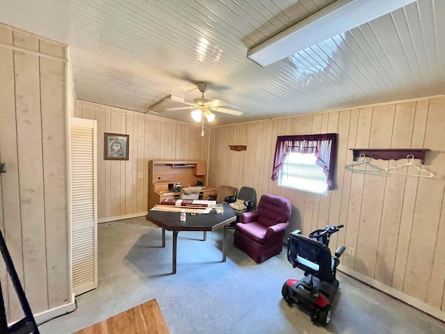 3020 SE 38th Ave, Okeechobee, FL 34974 - living area featuring unfinished concrete floors, wooden ceiling, a ceiling fan, wood walls, and baseboards