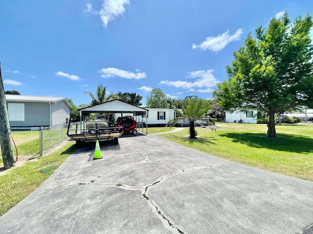 3020 SE 38th Ave, Okeechobee, FL 34974 - exterior space featuring fence, a carport, and driveway