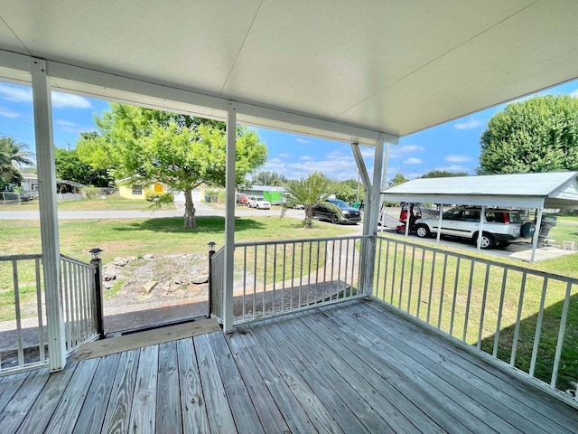 3020 SE 38th Ave, Okeechobee, FL 34974 - wooden deck featuring a carport and a yard