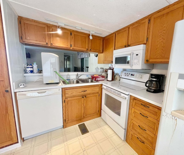 3020 SE 38th Ave, Okeechobee, FL 34974 - kitchen with a sink, white appliances, visible vents, light countertops, and light floors