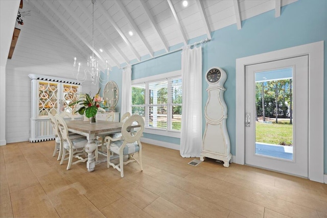 dining room with visible vents, beam ceiling, baseboards, light wood-style floors, and high vaulted ceiling