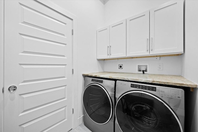 washroom with cabinet space and washing machine and clothes dryer