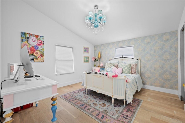 bedroom featuring baseboards, wallpapered walls, wood finished floors, and lofted ceiling