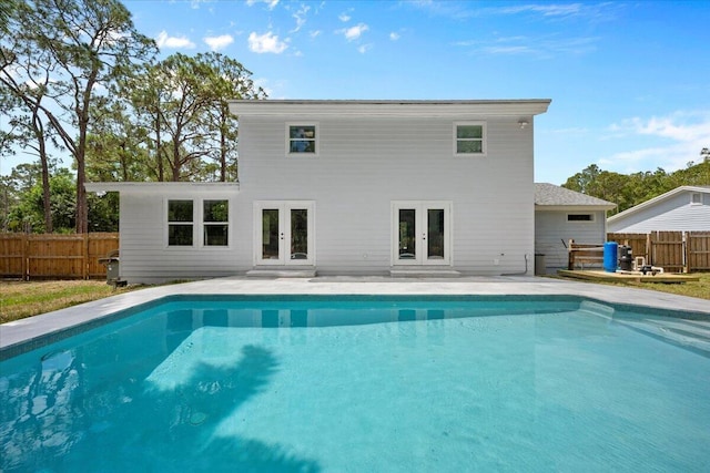 view of pool featuring fence, a fenced in pool, french doors, and a patio area