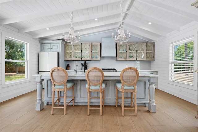 interior space featuring an inviting chandelier, light countertops, wooden ceiling, and light wood-type flooring