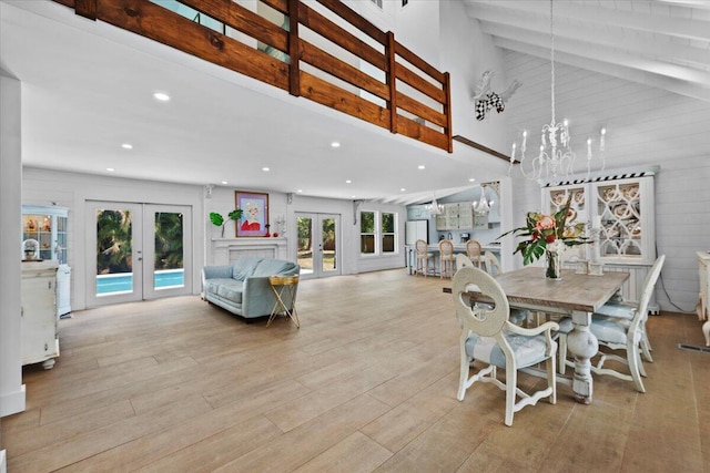 dining room featuring french doors, recessed lighting, wood finished floors, and a chandelier