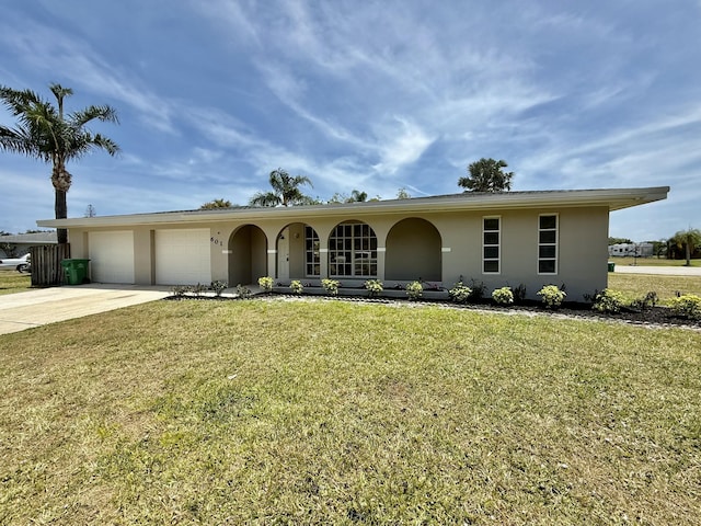 ranch-style house featuring a garage, a front lawn, stucco siding, and driveway