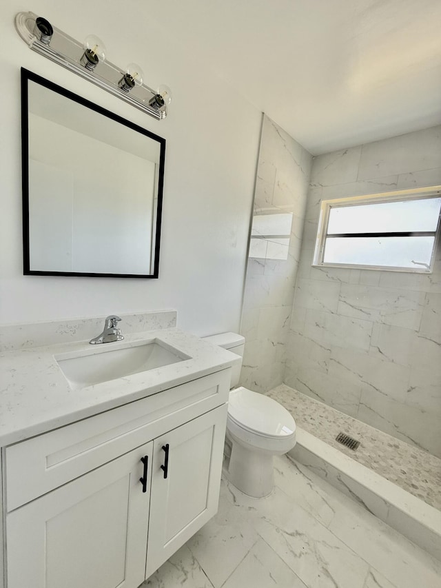 full bathroom featuring toilet, a shower stall, marble finish floor, and vanity
