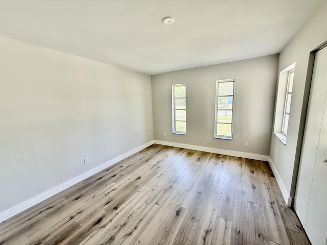 empty room featuring baseboards and wood finished floors