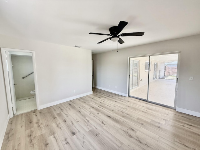 empty room with baseboards, ceiling fan, visible vents, and wood finished floors