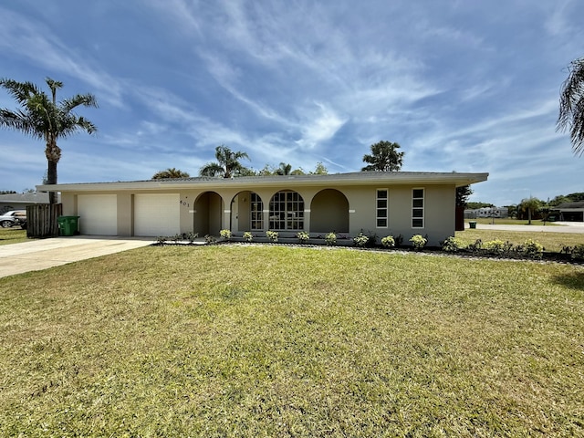 ranch-style house with a garage, stucco siding, driveway, and a front yard