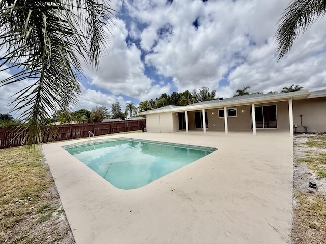 view of swimming pool with a fenced backyard, a fenced in pool, and a patio area