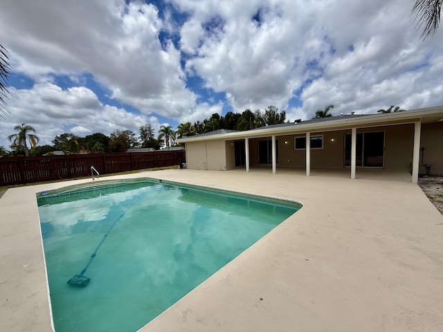 view of swimming pool featuring a patio, fence, and a fenced in pool