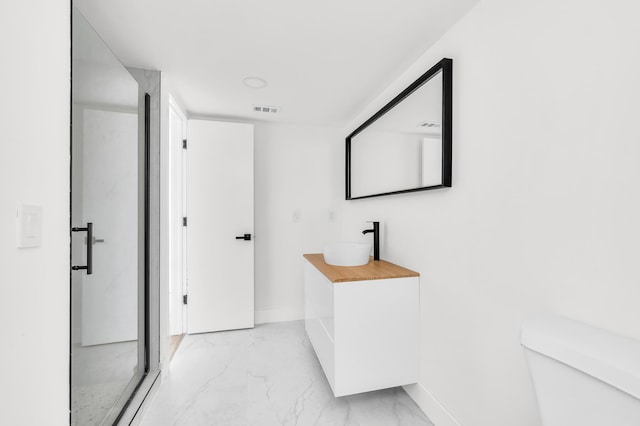 full bathroom featuring toilet, baseboards, visible vents, and marble finish floor