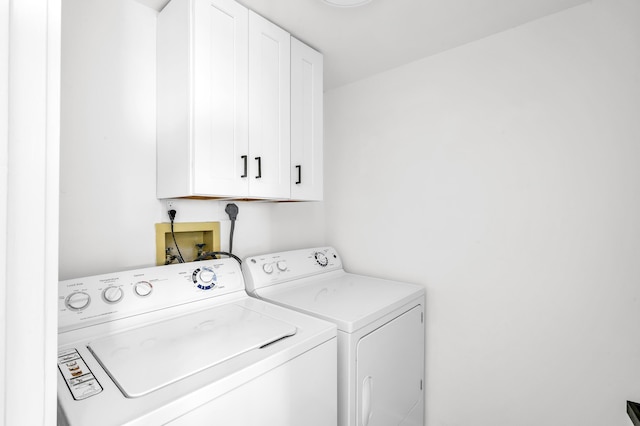 laundry area with cabinet space and independent washer and dryer