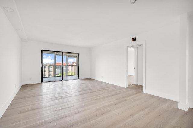 unfurnished room featuring light wood-style floors and baseboards