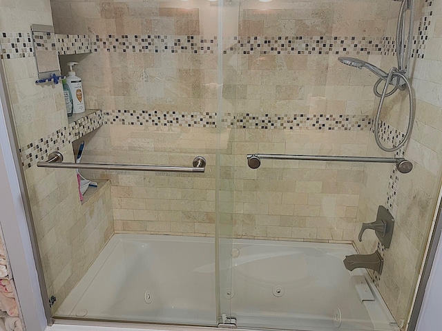 full bathroom with bath / shower combo with glass door