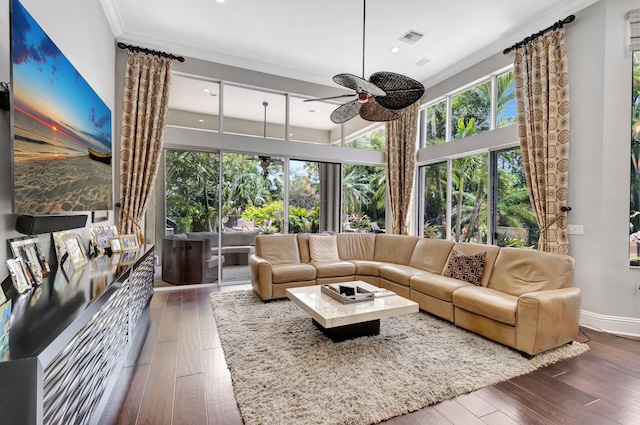 sunroom / solarium with visible vents, wood-type flooring, crown molding, baseboards, and recessed lighting