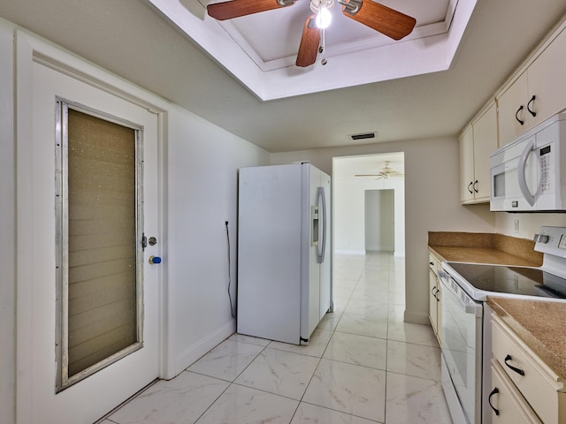 kitchen featuring marble finish floor, white appliances, baseboards, ceiling fan, and a tray ceiling