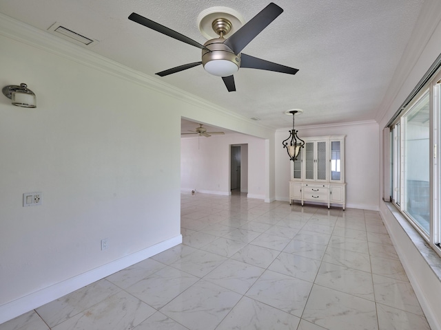 empty room with a ceiling fan, baseboards, ornamental molding, and marble finish floor