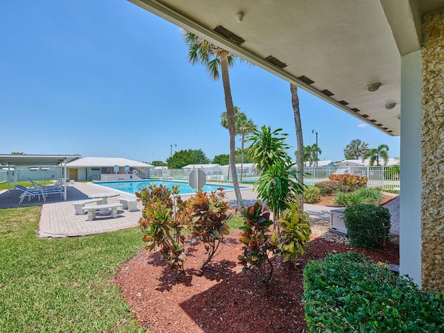 view of patio / terrace with fence and a community pool