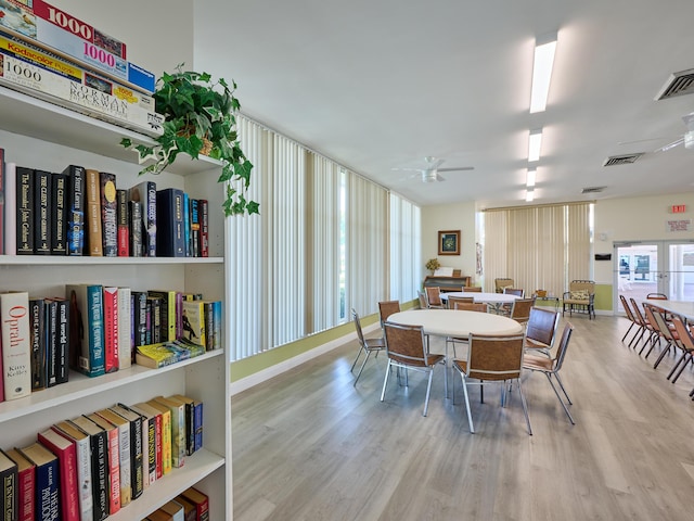 dining room featuring a ceiling fan, wood finished floors, and visible vents