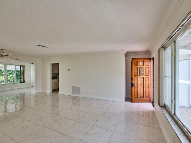 empty room featuring a textured ceiling, visible vents, ornamental molding, and baseboards