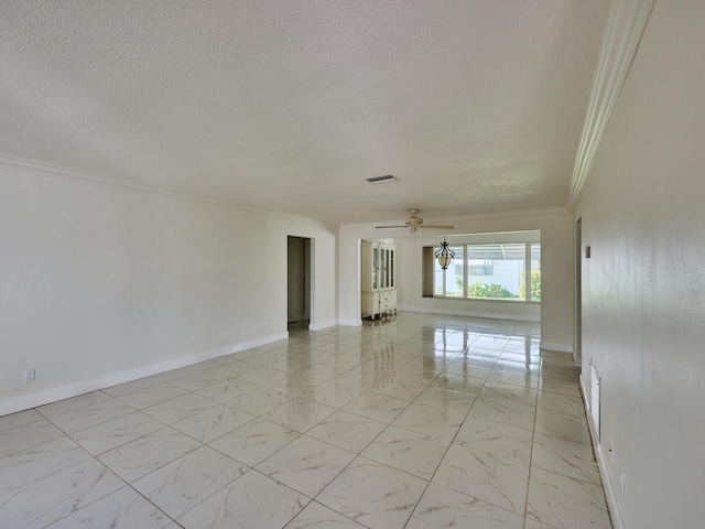 spare room featuring visible vents, ornamental molding, marble finish floor, baseboards, and a textured ceiling