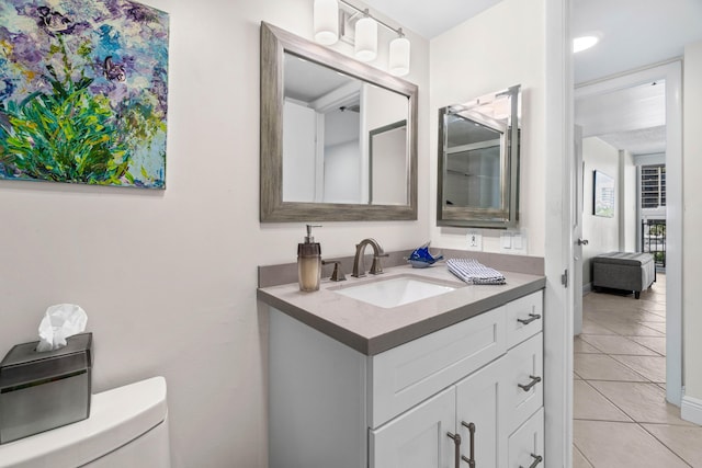 bathroom with vanity, toilet, and tile patterned floors