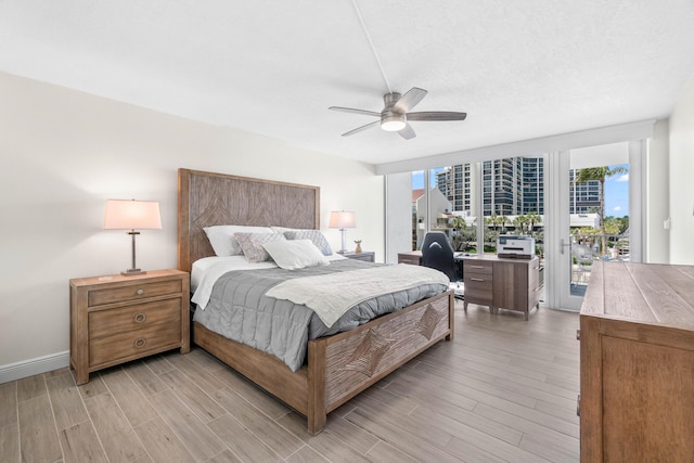 bedroom featuring light wood-style floors, access to outside, baseboards, and ceiling fan