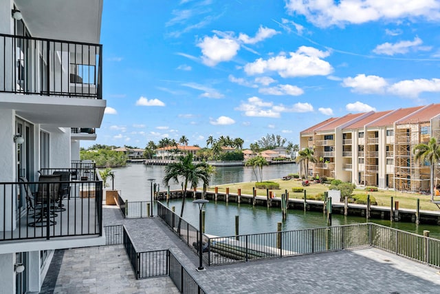view of dock featuring a water view and a balcony
