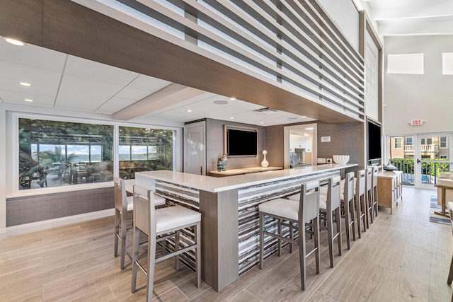 interior space featuring baseboards, light wood-style floors, and french doors