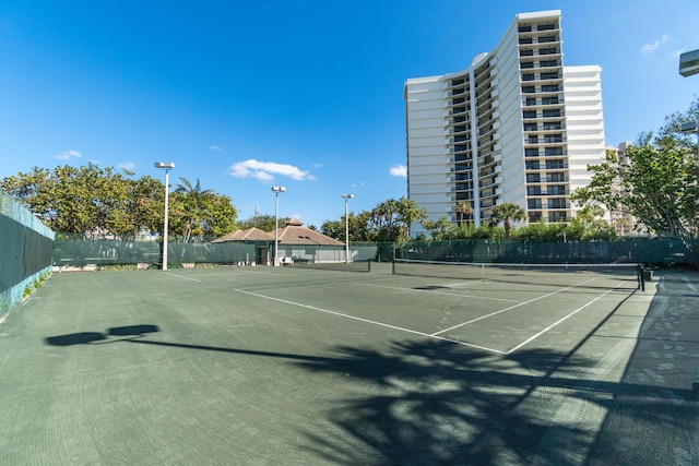 view of tennis court with fence