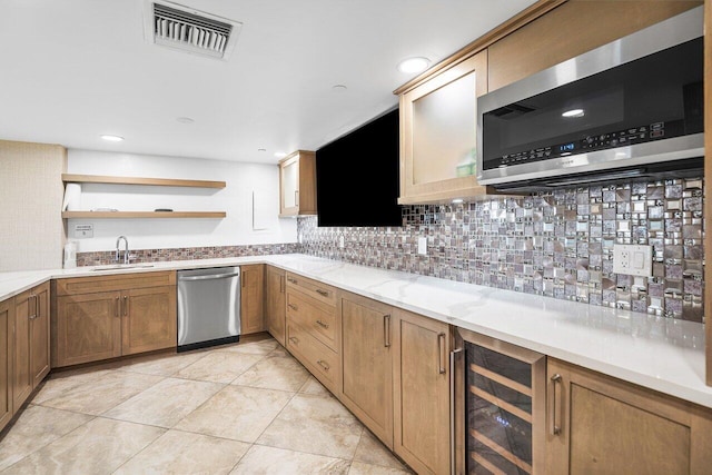 kitchen featuring beverage cooler, visible vents, a sink, open shelves, and appliances with stainless steel finishes
