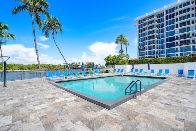 community pool featuring a patio area and fence