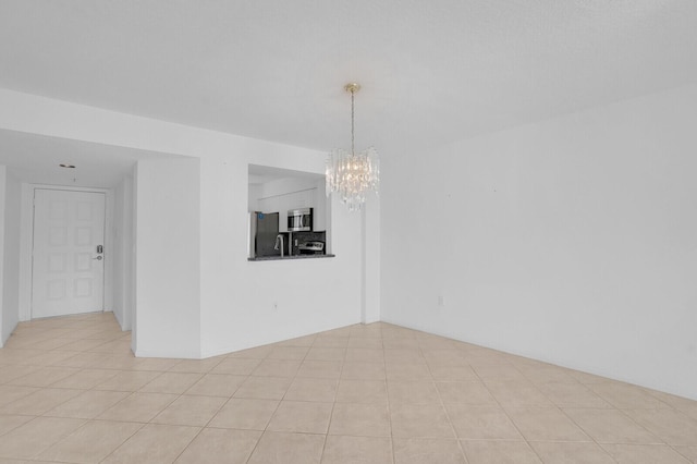 5874 Crystal Shores Dr Unit 308, Boynton Beach, FL 33437 - empty room featuring a chandelier